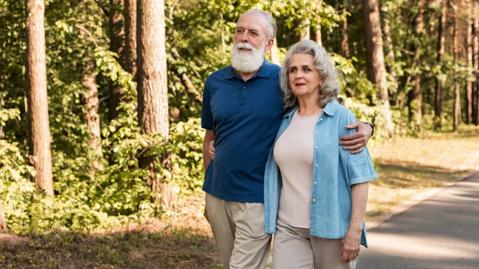 Herz-Kreislauf-Vorsorge durch Bewegung Ein älteres Paar beim gesundheitsfördernden Spaziergang im Wald – aktive Prävention von Herz-Kreislauf-Erkrankungen.