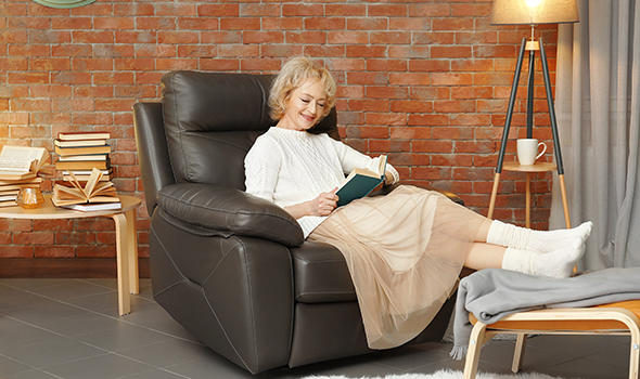 Freepik_happy-senior-woman-sitting-in-armchair-and-reading-book_Africa Studio.jpg