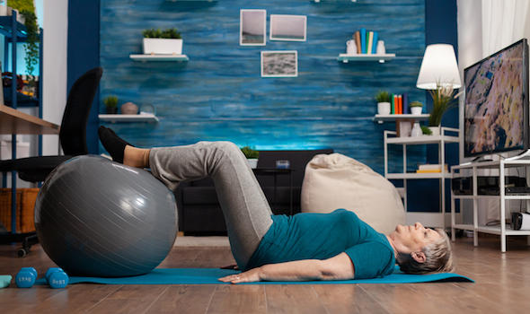 retired-senior-woman-doing-practicing-legs-up-exercise-using-swiss-ball-sitting-on-yoga-mat.jpeg