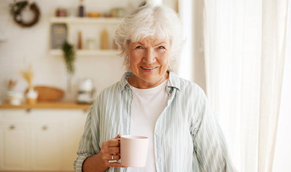 people-lifestyle-age-and-retirement-waist-up-image-of-cheerful-happy-european-female-pensioner-relaxing-at-home-having-herbal-tea-smiling-broadly.jpeg