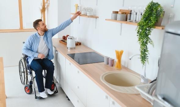 disabled-young-man-in-wheelchair-preparing-food-in-kitchen.jpeg