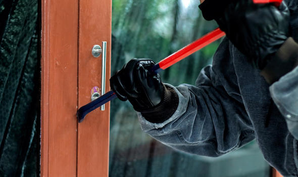 burglar-with-crowbar-trying-break-the-door-to-enter-the-house.jpeg